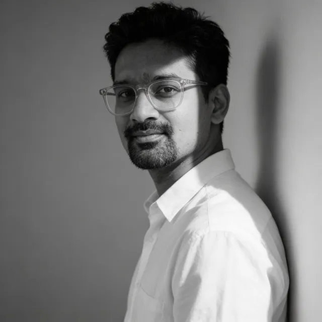 Black-and-white portrait of Dibyajyoti Kabi, co-founder of Hatchnix, wearing clear-framed glasses and a white shirt
